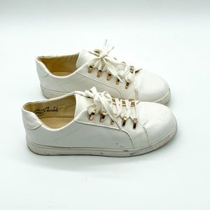 White sneakers with gold hardware